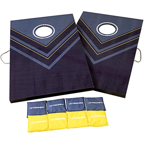 Two Triumph cornhole boards with blue and yellow squares.