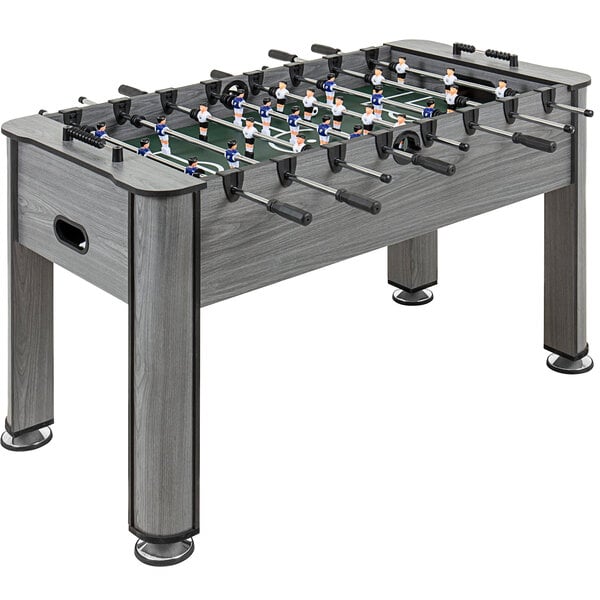 A Triumph Medford foosball table with small figures on it.