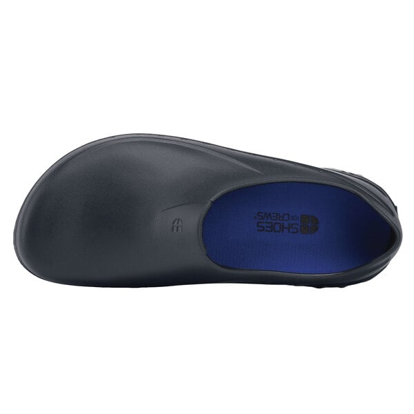 A black Shoes For Crews casual shoe with a blue sole.