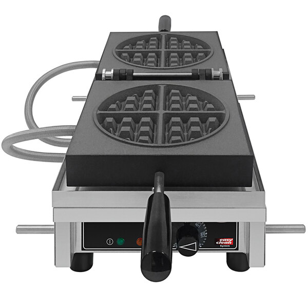 A Hatco Krampouz round Belgian waffle maker with a few waffles on top.