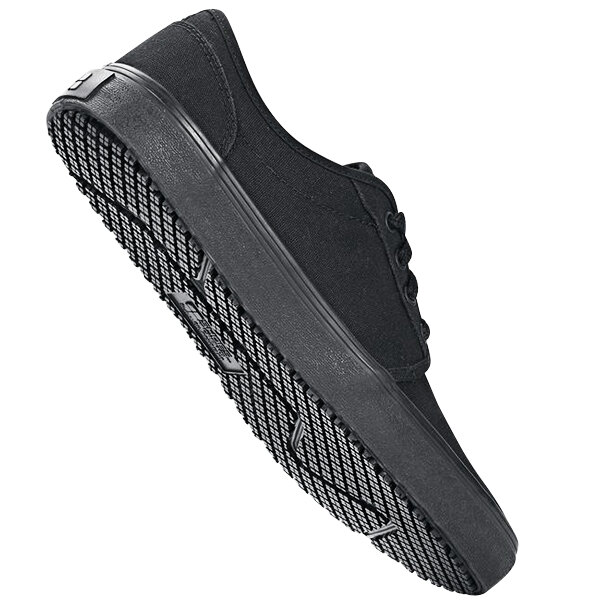 A black Shoes For Crews Merlin non-slip shoe with a rubber sole.