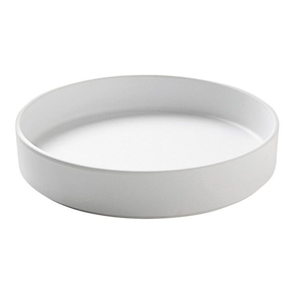 A white round Cal-Mil Hudson melamine plate with a raised rim.