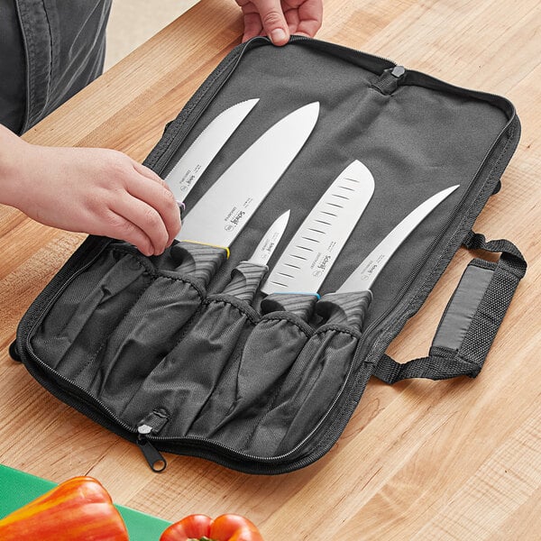 A person holding a Schraf Build-Your-Own 6-piece knife set in a black case.