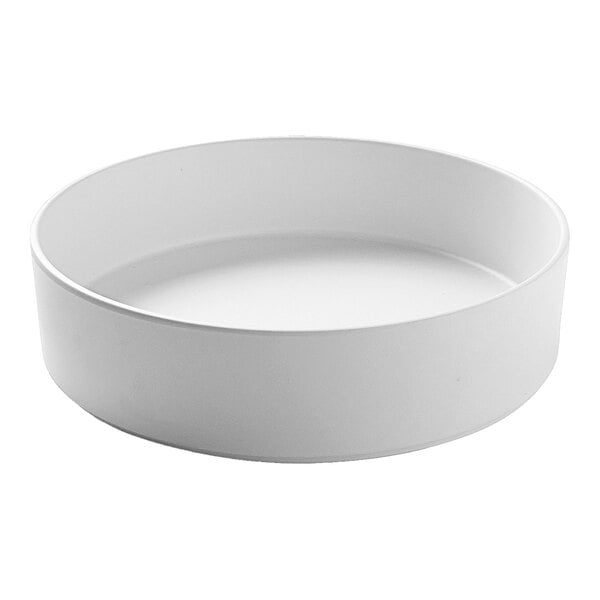 A white Cal-Mil stackable melamine bowl.
