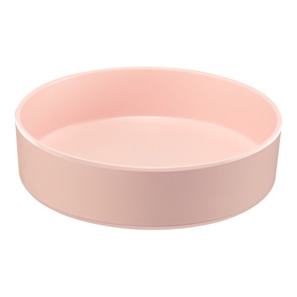 A round, blush-colored melamine bowl with a raised rim.