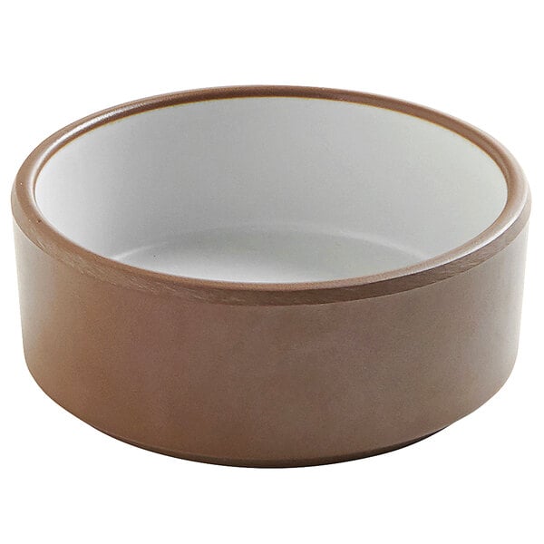 A brown stoneware ramekin with a white rim.