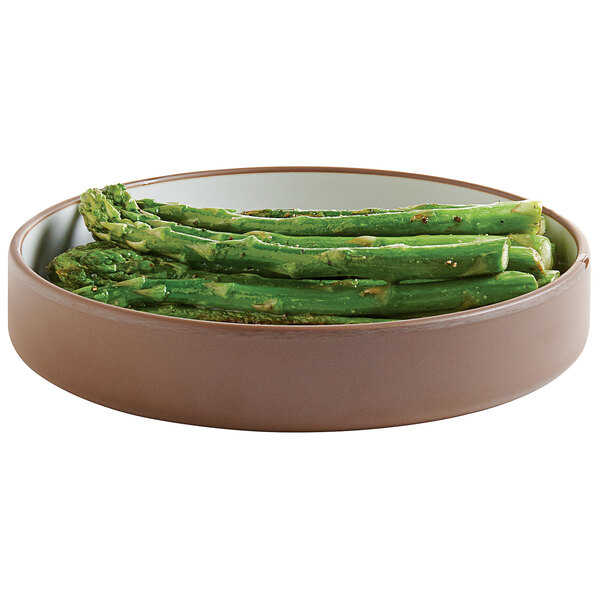 A Cal-Mil stoneware melamine plate with asparagus on it.