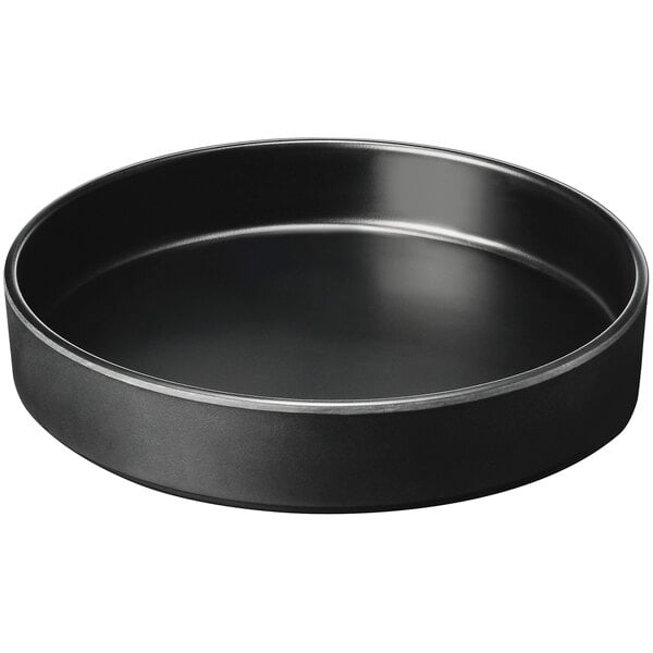 A black round Cal-Mil melamine plate with a raised rim.