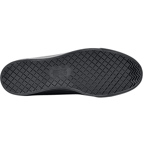 A close-up of a black Shoes For Crews Delray non-slip shoe with a black sole.