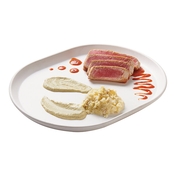 A white Cal-Mil melamine platter with food and sauces on a table.