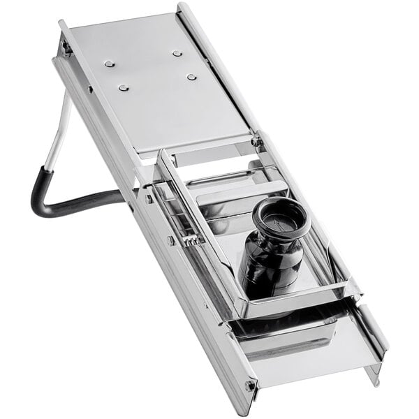 A stainless steel mandoline with a black container inside.