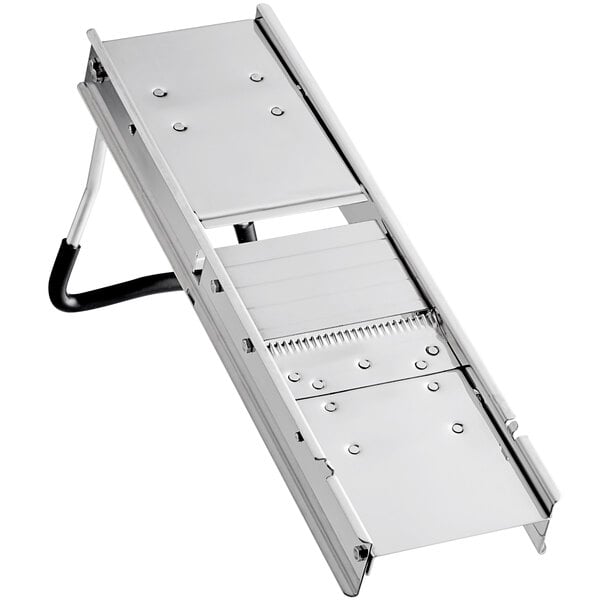 A stainless steel mandoline with two metal legs.