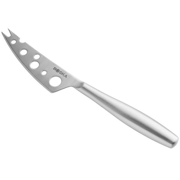 a silver cheese knife with holes