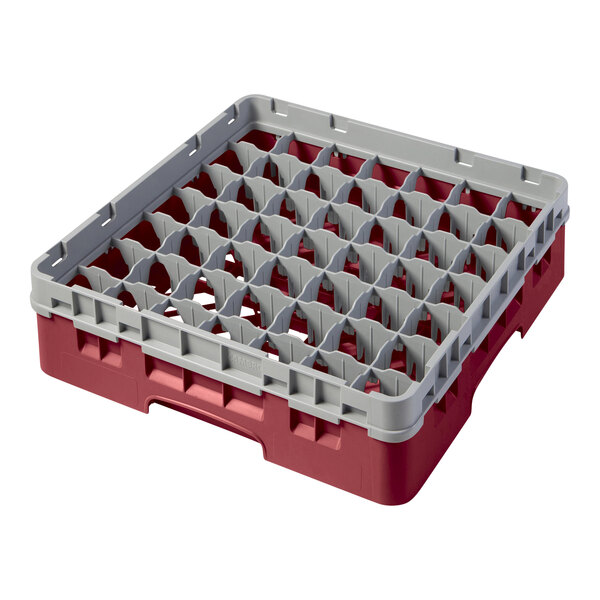 A red and grey plastic Cambro glass rack with many compartments.