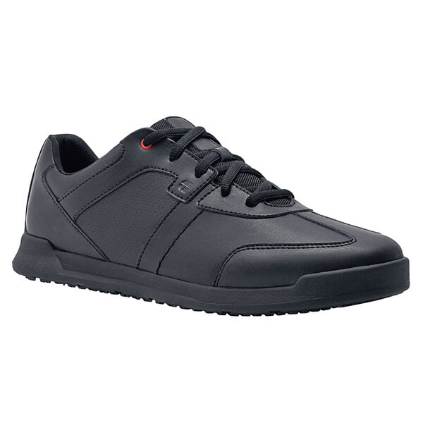 A black leather Shoes For Crews athletic shoe for men with laces.