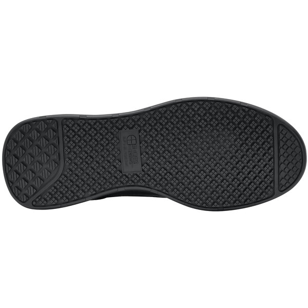 The sole of a black Shoes For Crews Liberty women's athletic shoe.
