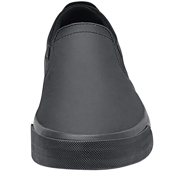 A black Shoes For Crews Ollie II slip-on shoe with a black rubber sole.