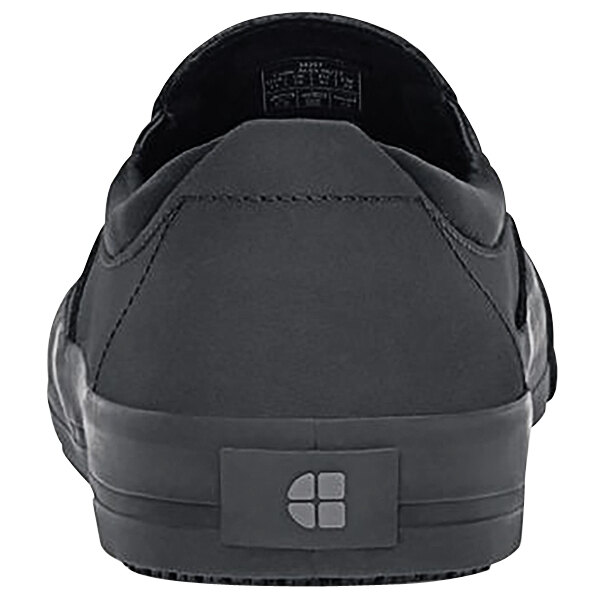 A black Shoes For Crews Ollie II casual shoe with a white and black sole and a logo on the side.