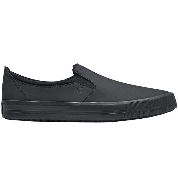 A black slip on Shoes For Crews unisex shoe with a rubber sole.