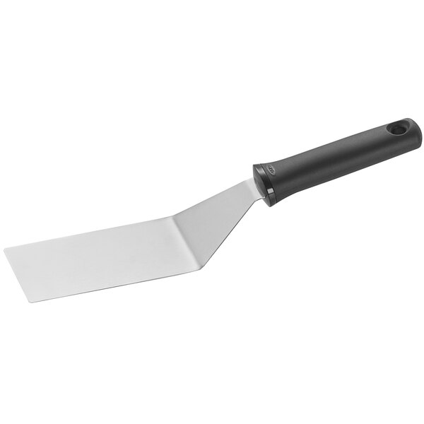 An OXO Good Grips spatula with a black handle and silver blade.