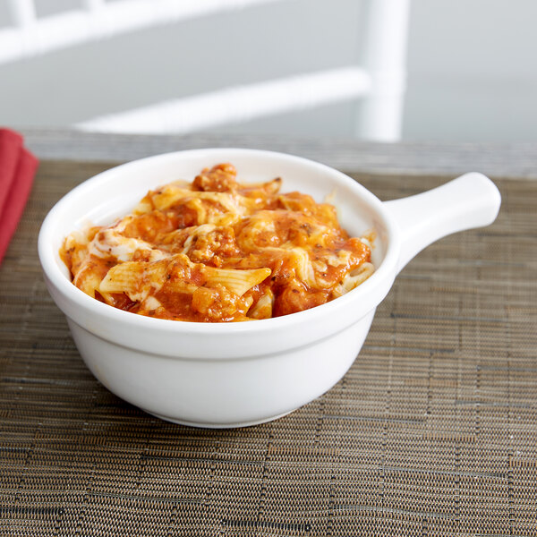 A Tuxton white china casserole bowl filled with pasta and meat sauce.