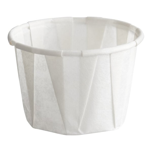A small white paper souffle or portion cup.