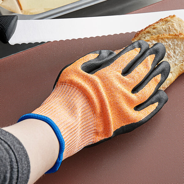 a pair of gloves with orange and white markings