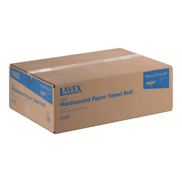 A large brown cardboard box with blue text indicating it contains hardwound paper towel rolls.