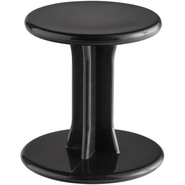 A black round plastic espresso tamper.