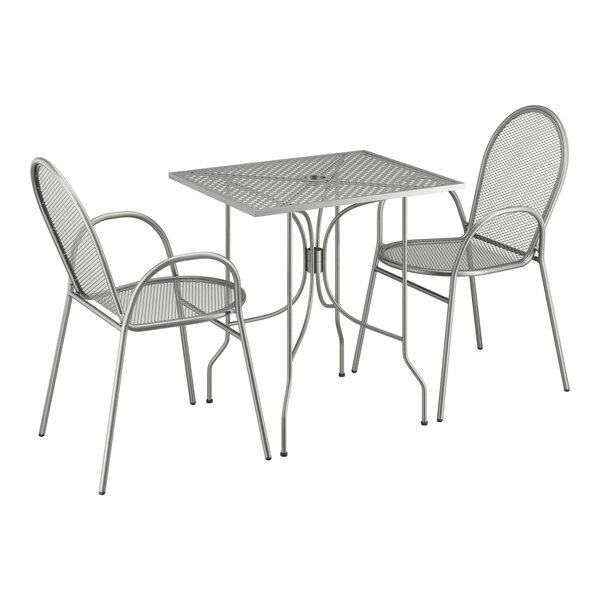 A Lancaster Table & Seating Harbor Gray metal rectangular outdoor table with ornate legs and two arm chairs.