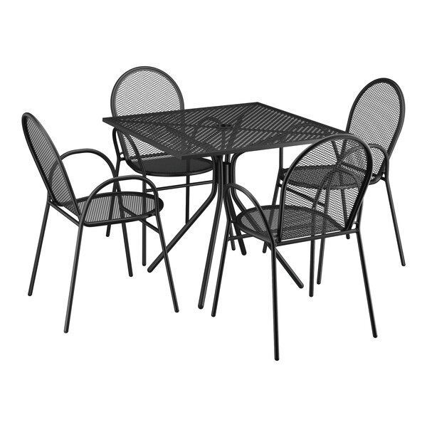 A Lancaster Table & Seating Harbor black metal table with four chairs on an outdoor patio.