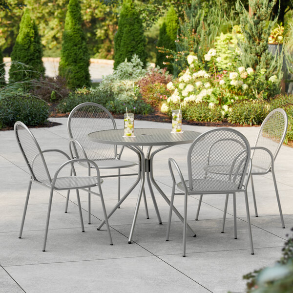 A Lancaster Table and Seating outdoor table and chairs on a patio.