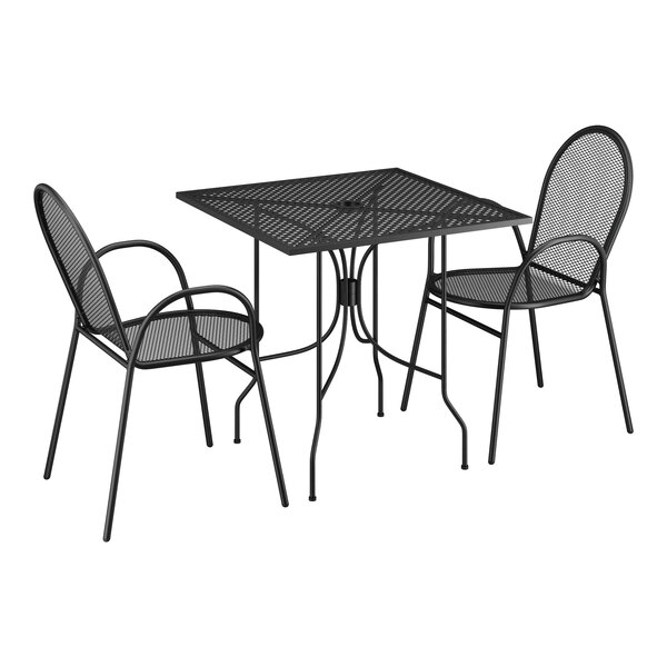 A Lancaster Table & Seating Harbor black metal table with ornate legs and 2 arm chairs.