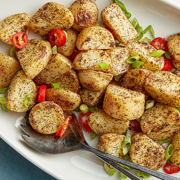 A plate of potatoes seasoned with Regal Salt, Pepper, and Garlic Seasoning Blend.