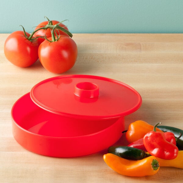 A red plastic HS Inc. tortilla server with a lid.