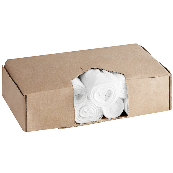 A cardboard box of rolled up clear Lavex Hercules trash bags.