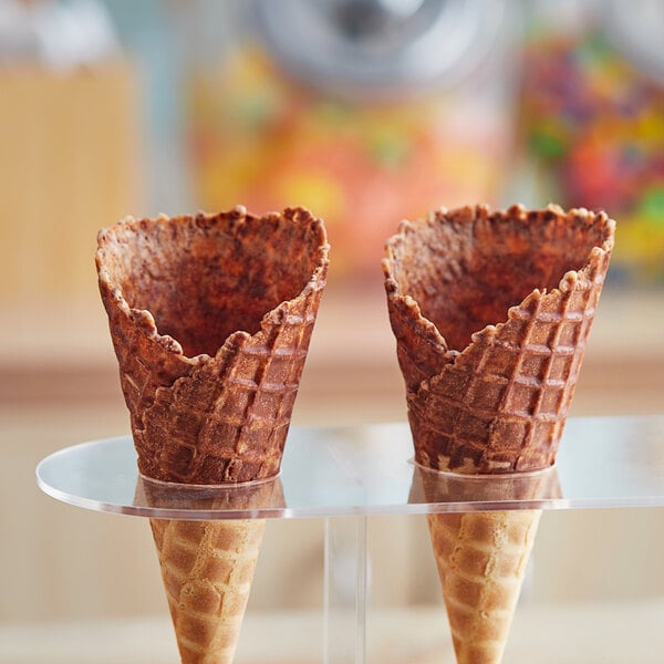 A waffle cone stand with two J. Hungerford Smith chocolate-dipped cones.