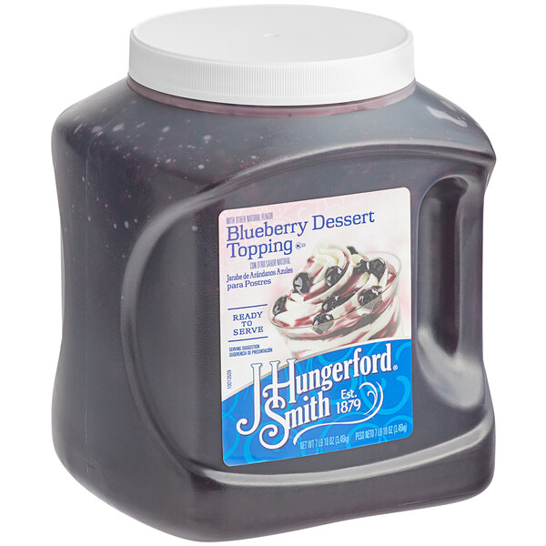 A plastic container of J. Hungerford Smith Blueberry Dessert Topping.