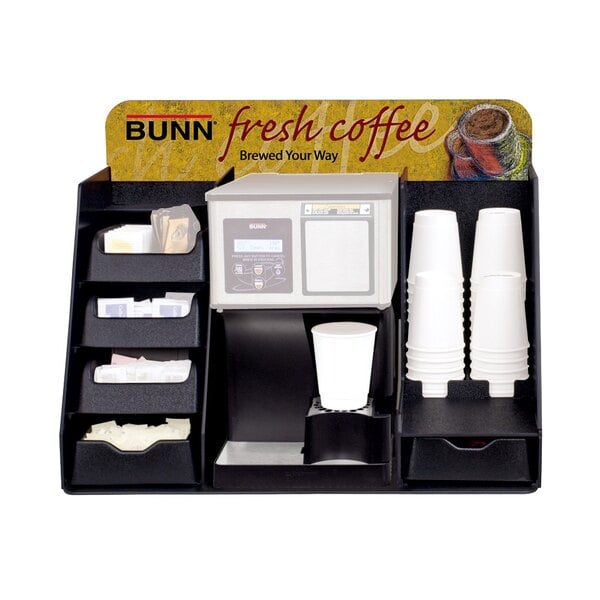 A white container with a black lid on a counter.