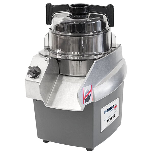 A Nemco stainless steel batch bowl food processor with a lid on top.