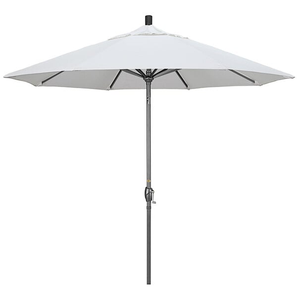 A white California Umbrella on a black pole.