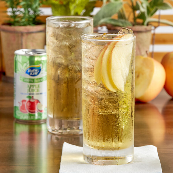 A glass of Ruby Kist apple juice with ice and fruit.