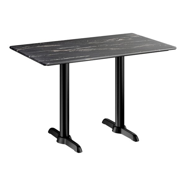 A rectangular standard height table with a smooth dark finish and two black end base plates.
