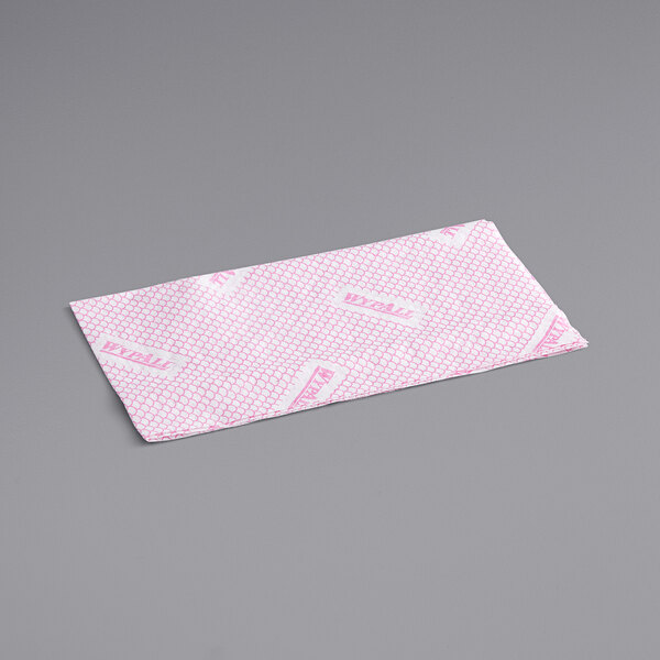 A red and white rectangular WypAll X70 foodservice wiper.