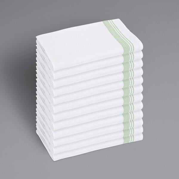 A stack of white towels with green stripes.