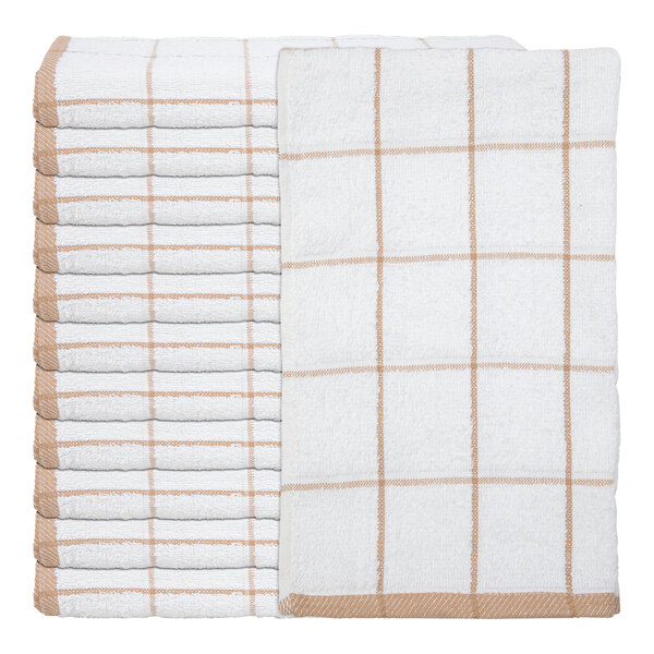 A stack of white towels with a tan windowpane pattern, with one towel displayed on top to show the full design.