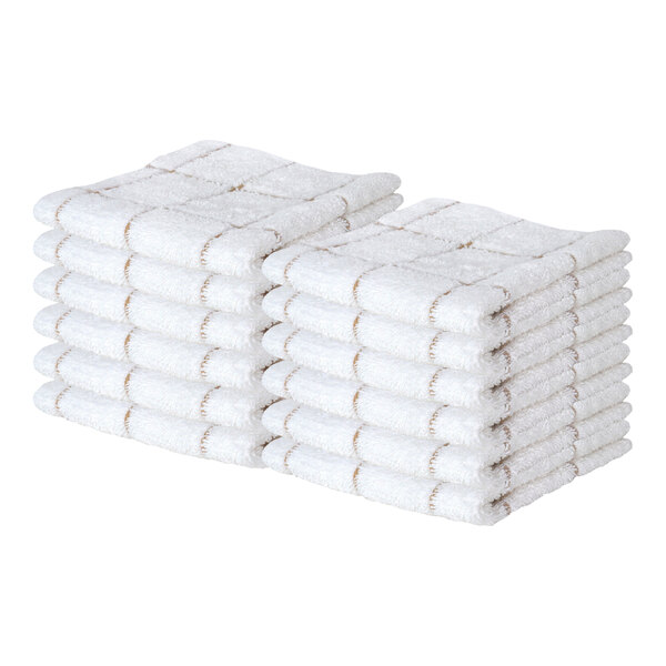 Two stacks of white terry cloth dish cloths with a tan windowpane pattern are shown.