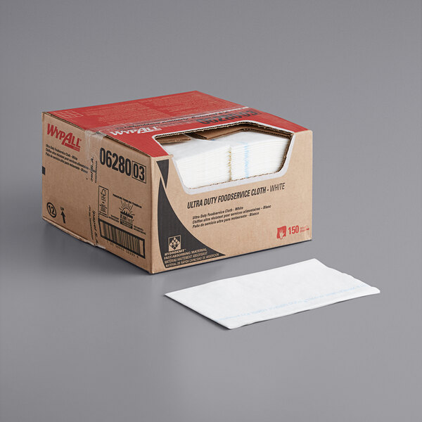 A case of white WypAll X80 foodservice wipers on a table.