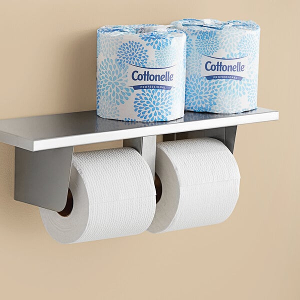 A shelf with two Cottonelle Professional toilet paper rolls.