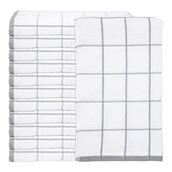 A stack of white kitchen towels with a gray windowpane pattern, with one towel displayed on top to show the full design.